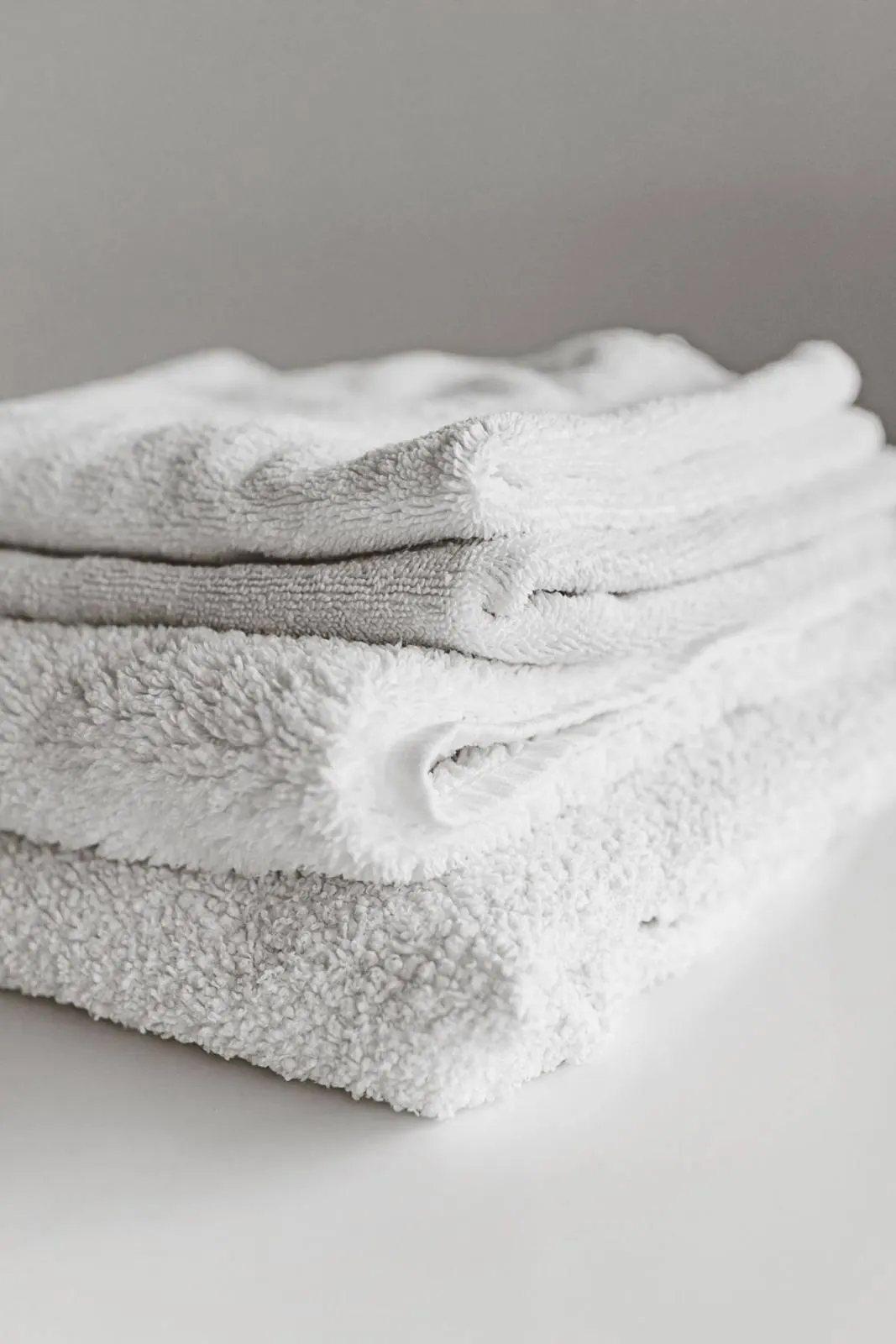 A stack of neatly folded clean white towels
