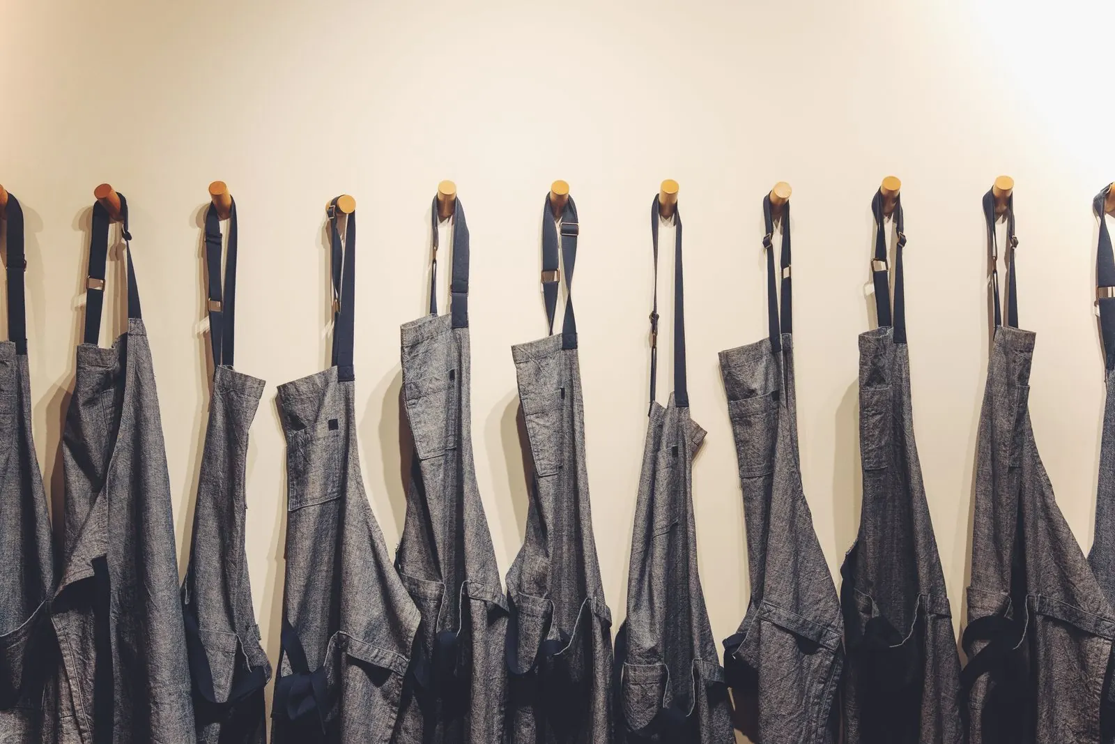 Work aprons hanging on hooks