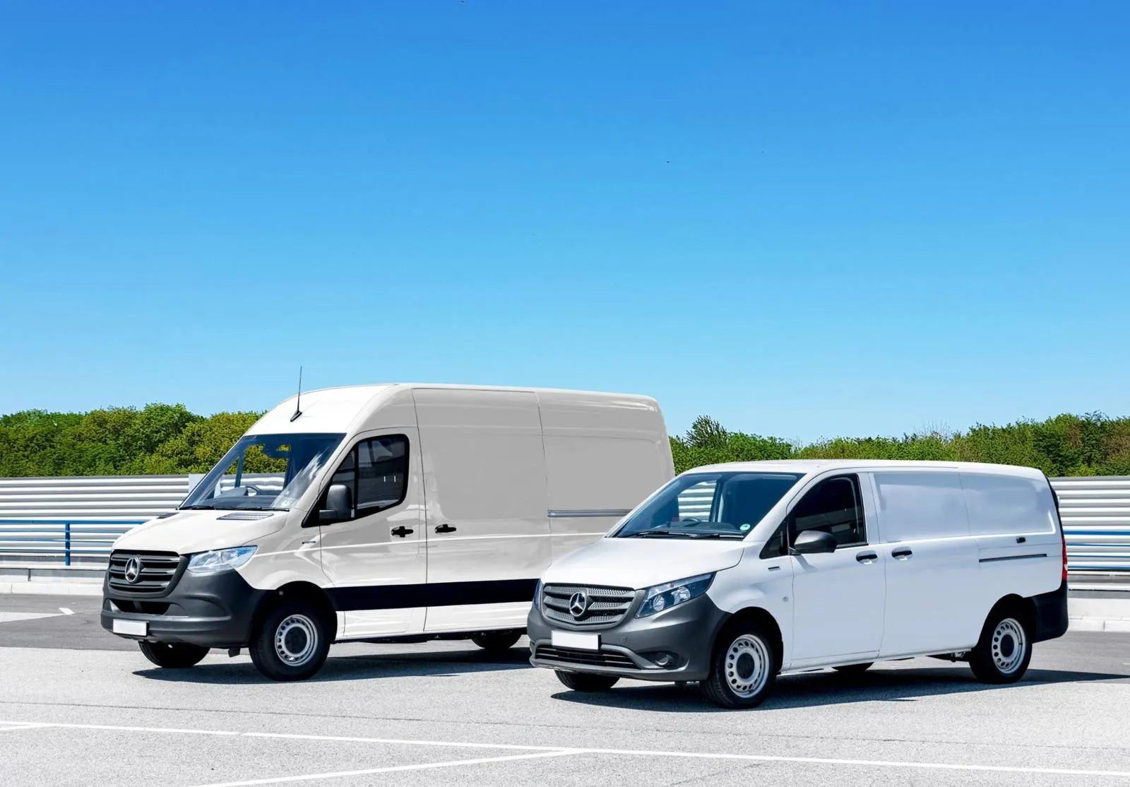Two white delivery vans parked side by side